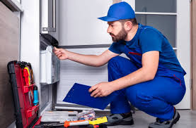 Refrigerator repair technician at work